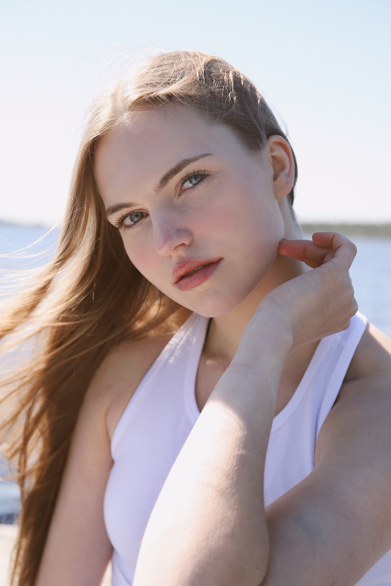 Close-up portrait of woman wearing Organic Yang white tank top by the lake